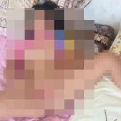 She sang a song while lying in bed, looking a little sleepy